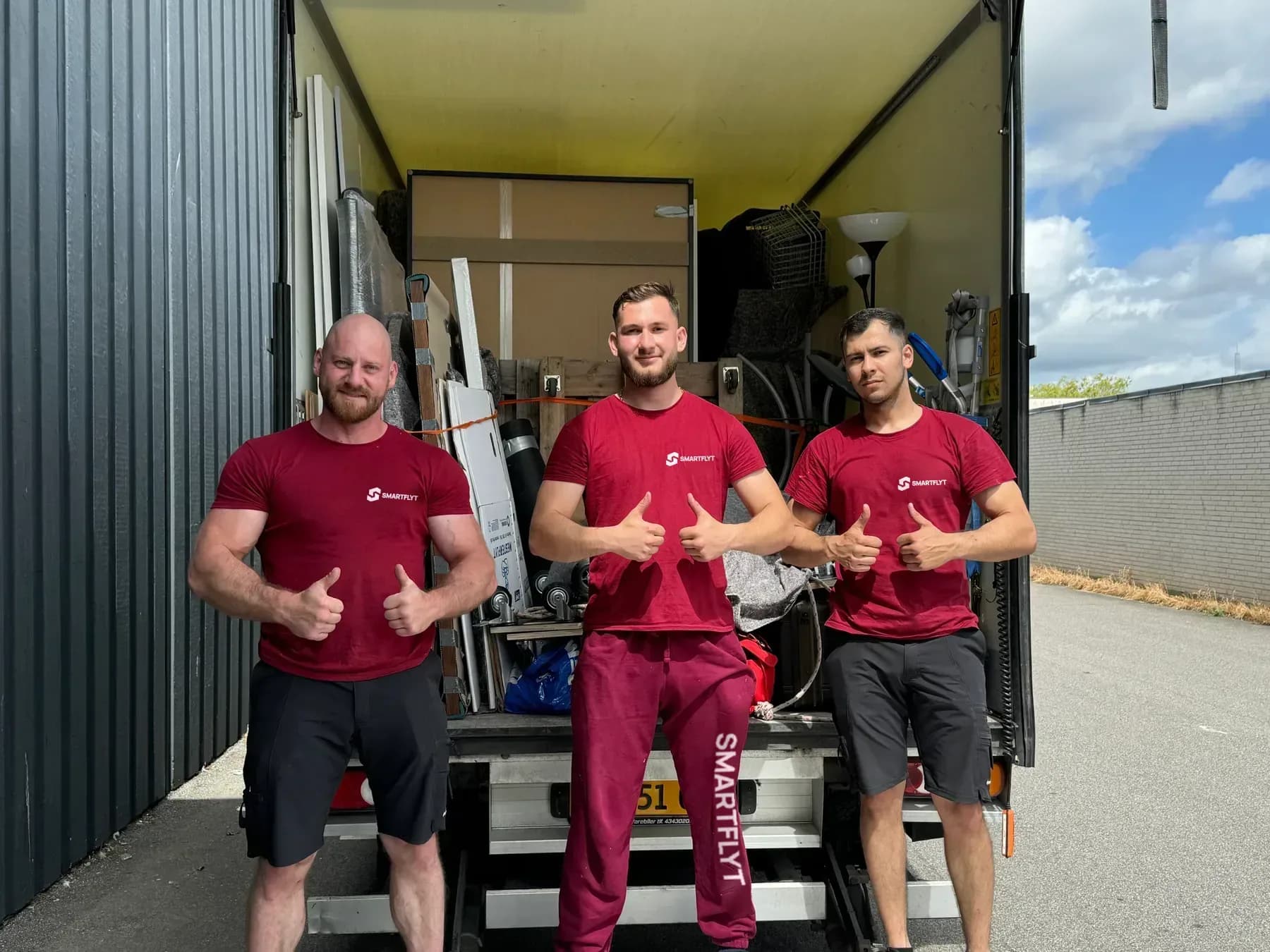 Three Smart Flyt movers at the loading ramp of a moving van