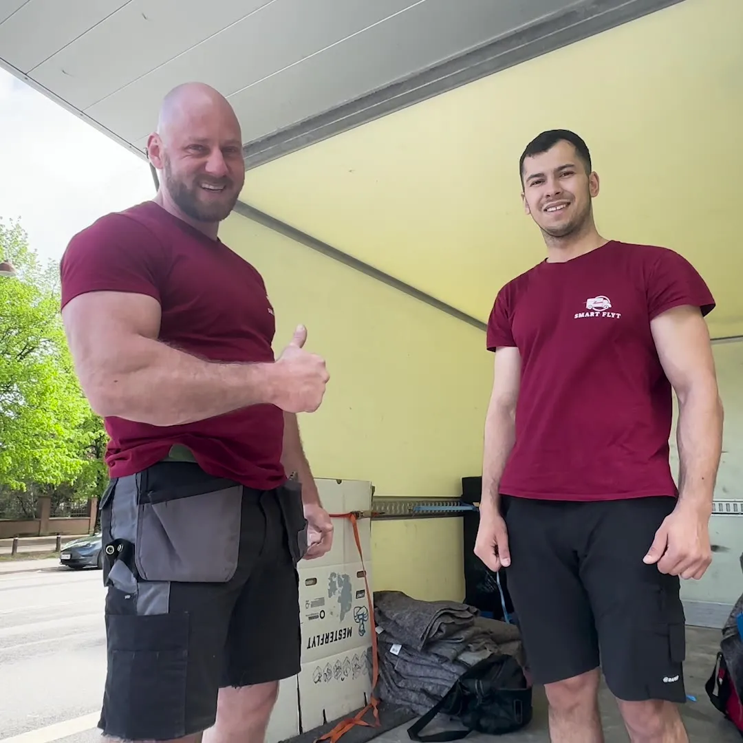 Two Smart Flyt movers ready to move a piano by the moving van