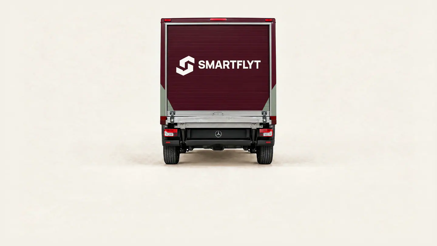 A moving box is loaded into the van, which already holds other boxes